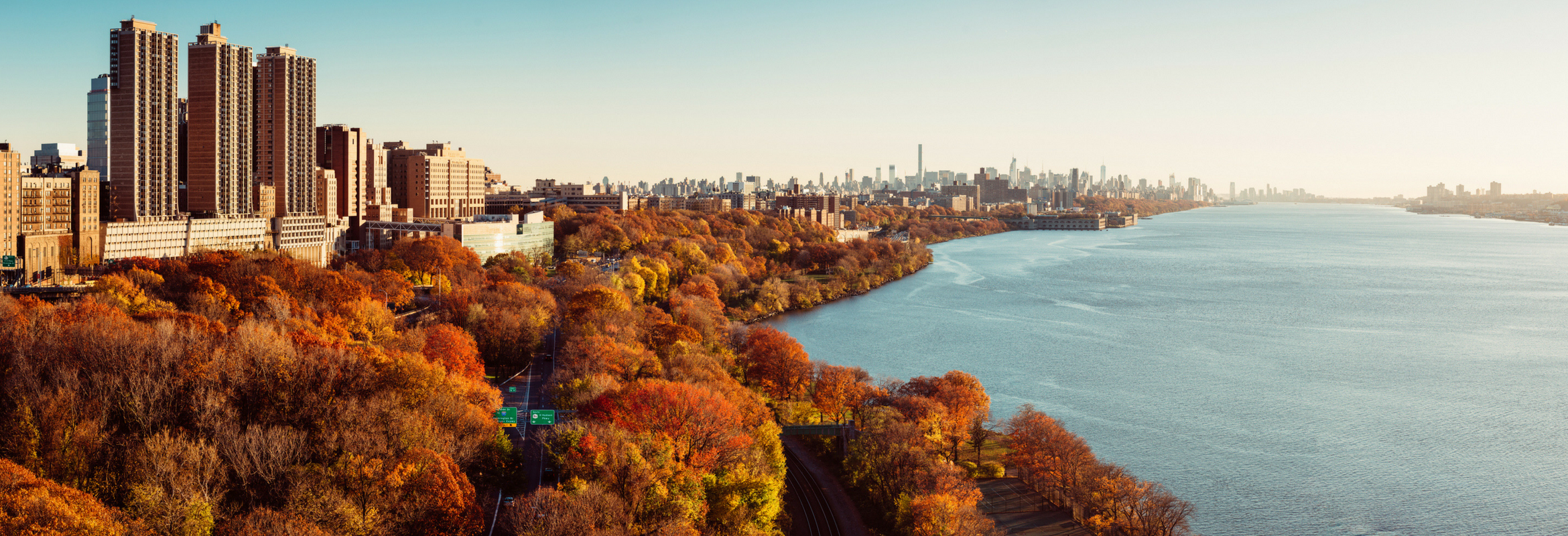 An image of a city against fall foliage.
